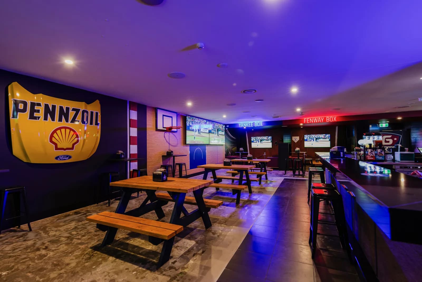 Picnic-table function area beside the KG Sports Bar bar and live sports screens